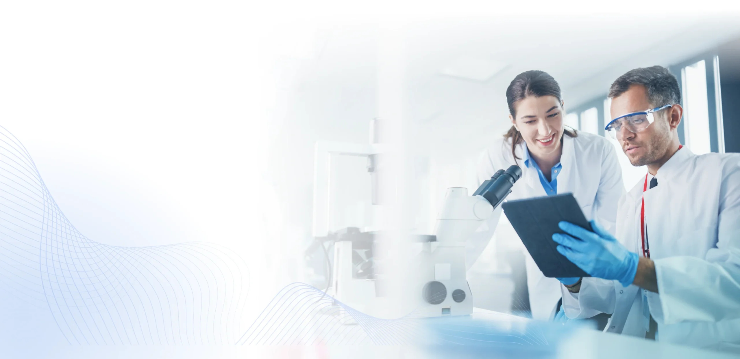 Two scientists reviewing results on a tablet